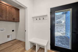 Mudroom with light wood-type flooring and baseboards