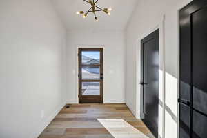 Entryway featuring a chandelier and wood finished floors