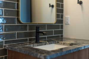 Bathroom view of tasteful backsplash and vanity