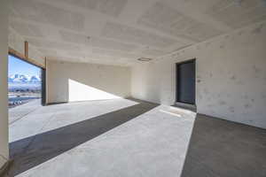 Unfurnished room featuring a mountain view and concrete floors