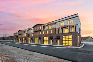 View of back of property at dusk