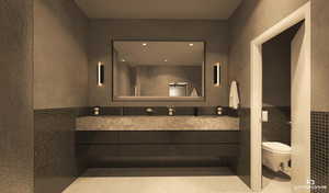 Bathroom with tile walls, vanity, a wainscoted wall, and a textured wall