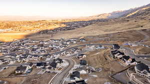 Aerial view of residential area featuring a mountain backdrop and a desert landscape