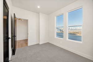 Unfurnished room with light colored carpet and recessed lighting