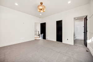 Unfurnished bedroom with carpet, recessed lighting, and ensuite bathroom