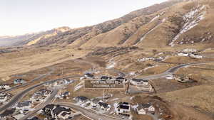 Aerial overview of property's location featuring a mountainous background and nearby suburban area