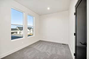 Spare room with light carpet and recessed lighting