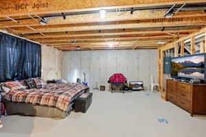Bedroom with concrete flooring and electric panel