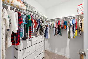 Spacious closet with light colored carpet