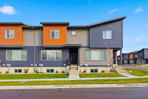 Contemporary home featuring a residential view and a front yard