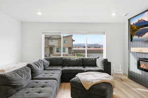 Living room featuring a fireplace, wood finished floors, and recessed lighting