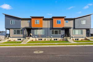 Contemporary home with a residential view, a front yard, and entry steps
