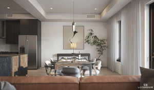 Living room featuring a tray ceiling, recessed lighting, and light wood-style floors