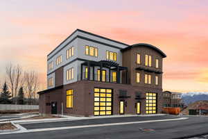 View of front of property featuring brick siding and a pergola