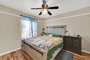 Bedroom with ceiling fan and light wood finished floors