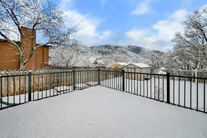 Backyard featuring a shed, fence, and a Trex deck with mountain views