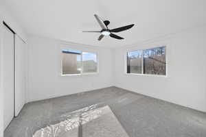 Unfurnished bedroom with a ceiling fan, a closet, and carpet floors