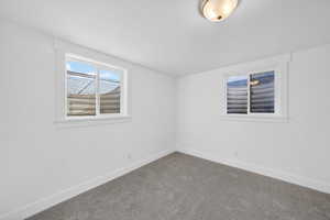 Empty room with baseboards and carpet floors