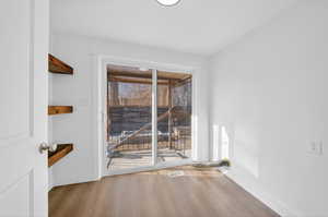 Spare room featuring light wood finished floors and baseboards