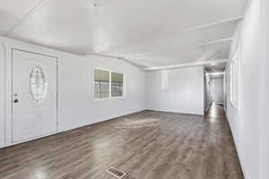 Entryway with wood finished floors and baseboards