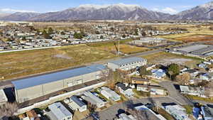 Aerial overview of property's location featuring an industrial area and a mountain backdrop