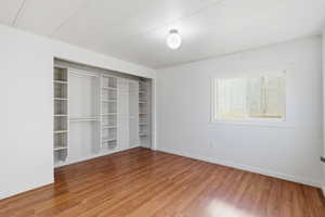 Unfurnished bedroom with light wood-style flooring and a closet