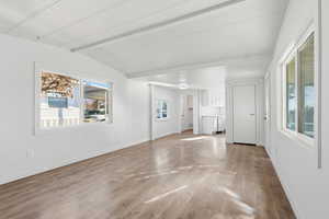 Empty room with plenty of natural light and light wood-style flooring