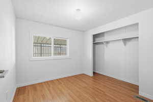 Unfurnished bedroom with a closet and light wood-type flooring