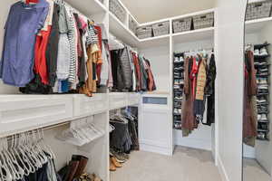 Walk in closet featuring light carpet