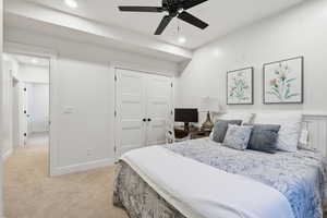 Bedroom featuring light colored carpet, ceiling fan, a closet, and recessed lighting