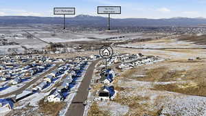 Aerial view of property's location featuring nearby suburban area and mountains