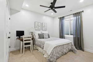 Bedroom with a ceiling fan, light carpet, an office area, and recessed lighting