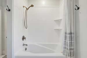 Bathroom featuring shower / bath combo with shower curtain