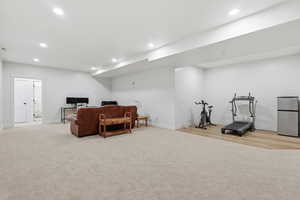 Living area featuring recessed lighting and light colored carpet