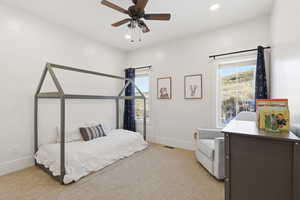 Bedroom featuring light colored carpet, ceiling fan, multiple windows, and recessed lighting
