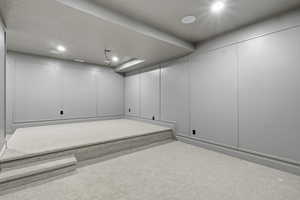 Carpeted spare room featuring a decorative wall and recessed lighting