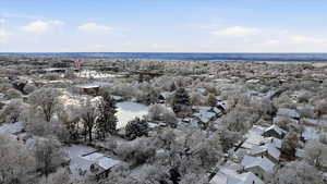 Aerial view of property and surrounding area with nearby suburban area