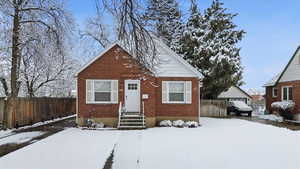 Bungalow featuring brick siding and entry steps