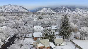 Snowy aerial view with a mountain view and a forest view