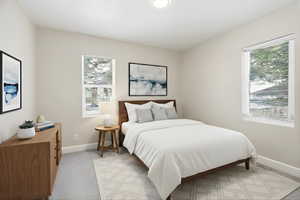Upstairs Bedroom 1 featuring baseboards and light carpet