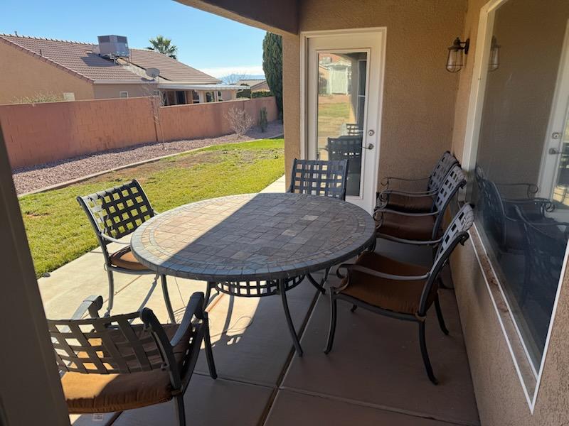 Fenced backyard featuring a patio and outdoor dining space