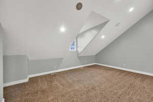 Bonus room with carpet flooring, recessed lighting, and lofted ceiling