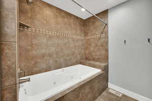 Bathroom featuring a combined bath / shower with jetted tub, recessed lighting, and tile patterned flooring