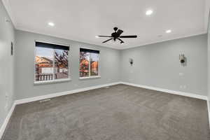 Carpeted spare room featuring crown molding, a ceiling fan, and recessed lighting