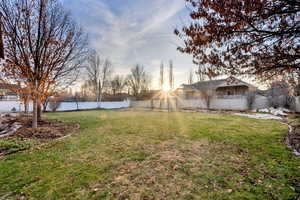 Yard at dusk with a fenced backyard