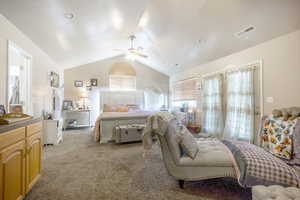 Bedroom featuring carpet flooring, lofted ceiling, and a ceiling fan