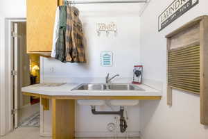 Kitchen featuring light countertops and a sink