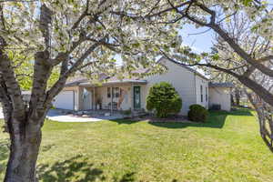View of front of property with a front lawn and a garage
