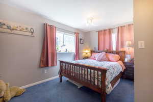 Carpeted bedroom featuring baseboards