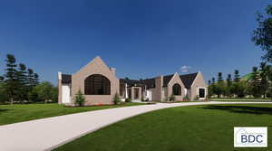 French country home featuring a front yard